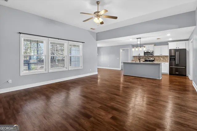 a view of a kitchen with a kitchen island wooden floor and a window