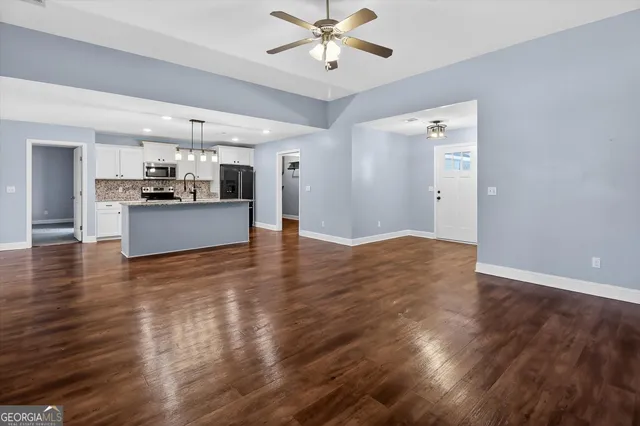 a view of a kitchen with a sink and cabinets