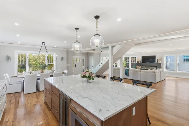 a kitchen with a table a stove and wooden floor