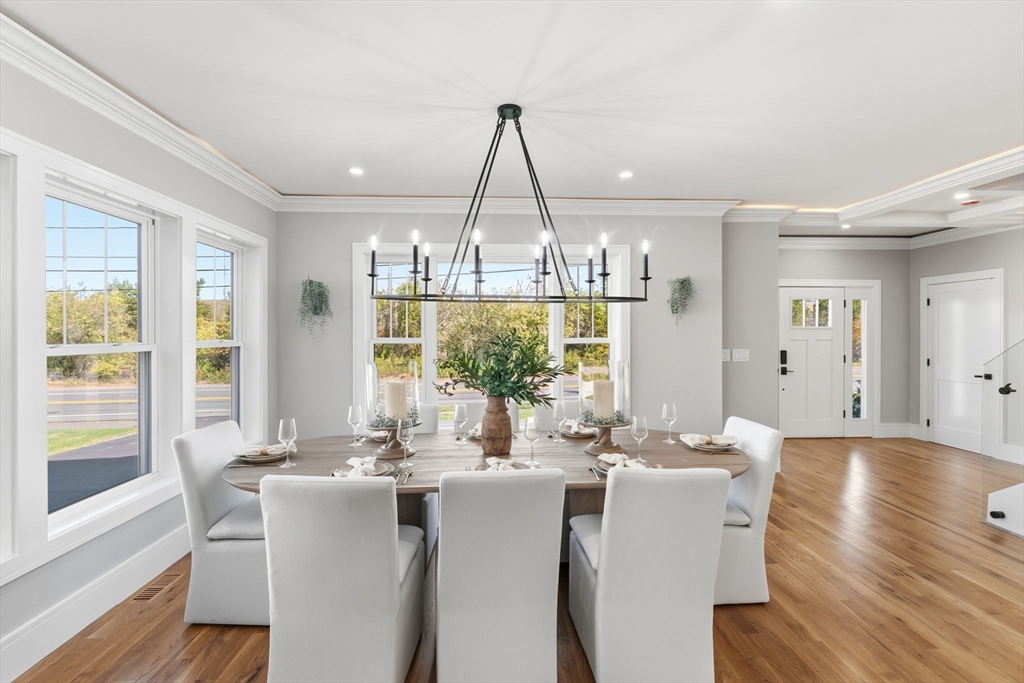 143 Hunting Road Needham, MA 02494 - Photo 14 of 42 a dining room with furniture a chandelier and wooden floor