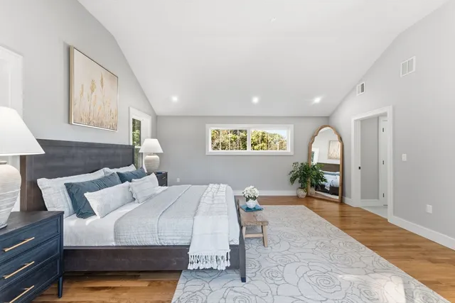 a bedroom with a bed and a large window