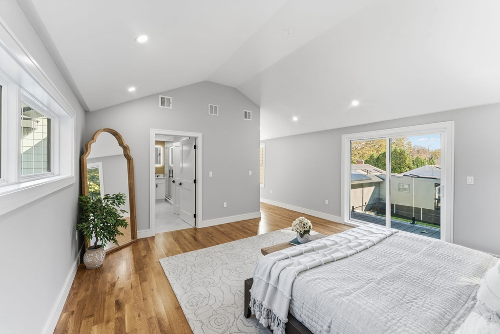 143 Hunting Road Needham, MA 02494 - Photo 25 of 42 a bedroom with a bed and a large window