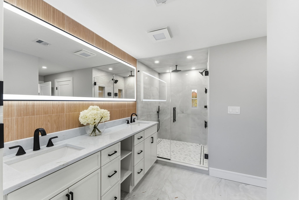 143 Hunting Road Needham, MA 02494 - Photo 26 of 42 a spacious bathroom with a double vanity sink a mirror and a shower