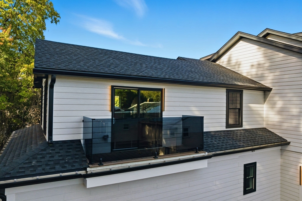 143 Hunting Road Needham, MA 02494 - Photo 27 of 42 a front view of a house with garage