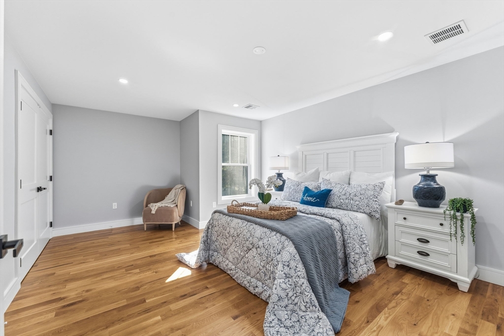 143 Hunting Road Needham, MA 02494 - Photo 31 of 42 a bedroom with a large bed and wooden floor