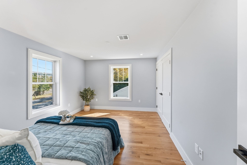 143 Hunting Road Needham, MA 02494 - Photo 33 of 42 a spacious bedroom with a bed and a window