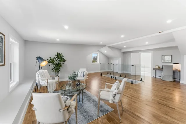 a view of an empty room with wooden floor and closet