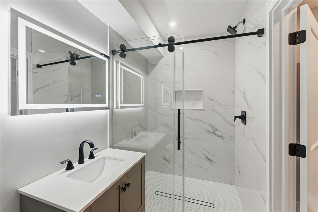 143 Hunting Road Needham, MA 02494 - Photo 39 of 42 a bathroom with a sink and mirror