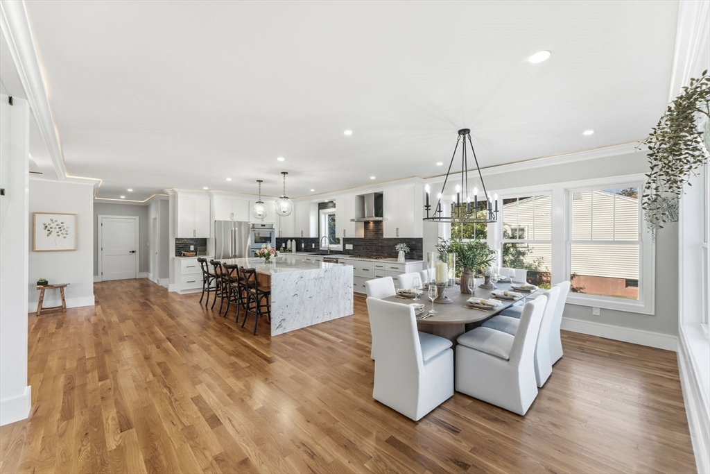 143 Hunting Road Needham, MA 02494 - Photo 7 of 42 a living room with couches and kitchen view with wooden floor