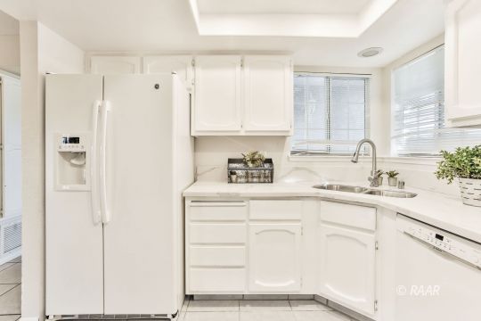 528 South Sorrel Street Ridgecrest, CA 93555 - Photo 5 of 27 a kitchen with white cabinets and a sink