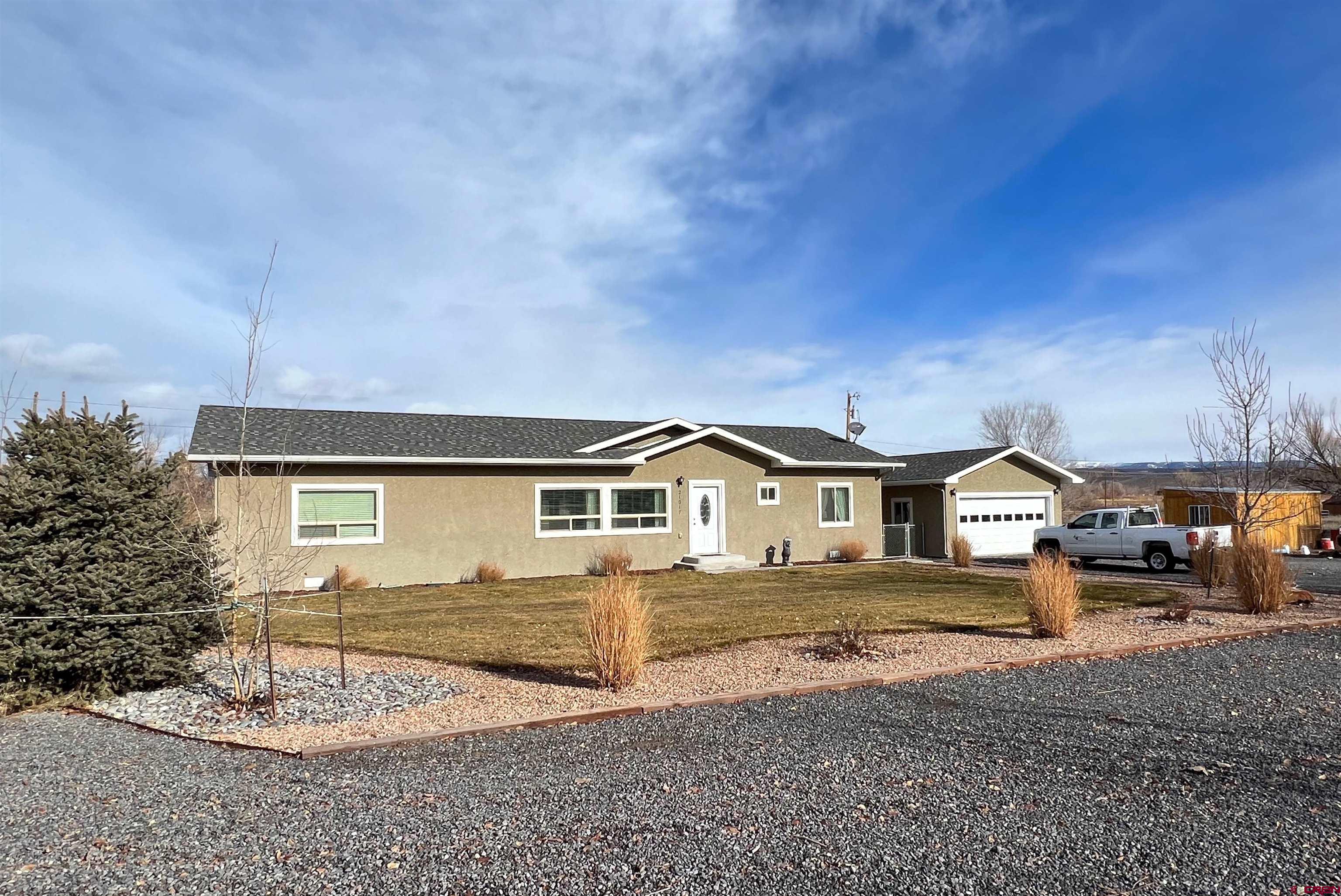 21017 Austin Road Austin, CO 81410 - Photo 3 of 28 a front view of a house with a yard