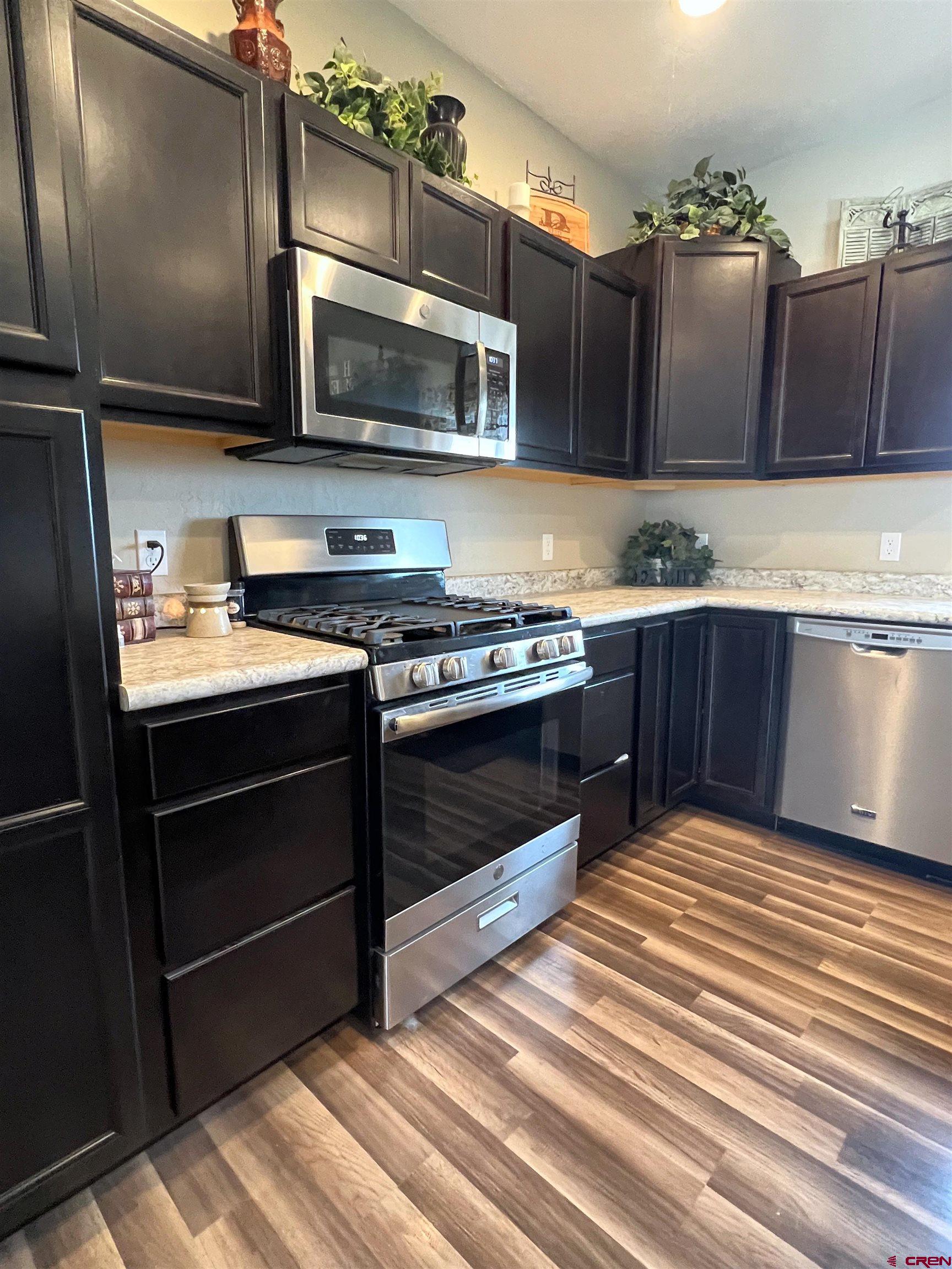 21017 Austin Road Austin, CO 81410 - Photo 8 of 28 a kitchen with stainless steel appliances granite countertop a stove and a microwave