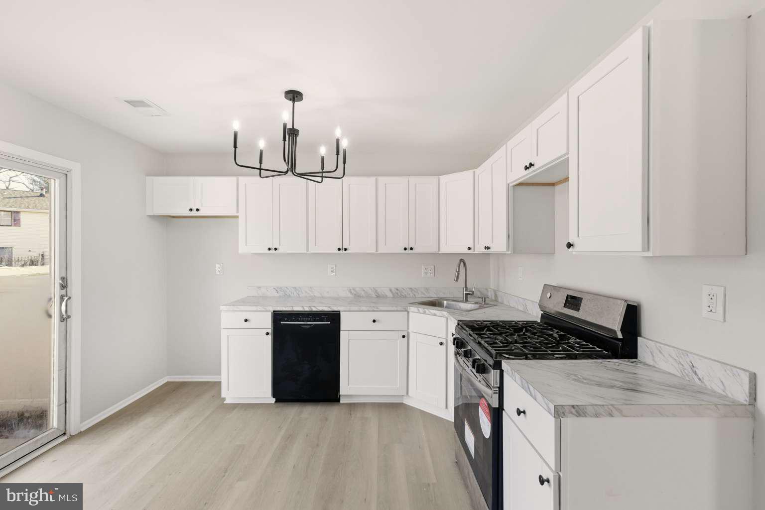 804 Mason Run Pine Hill, NJ 08021 - Photo 9 of 15 a kitchen with stainless steel appliances a stove sink and cabinets