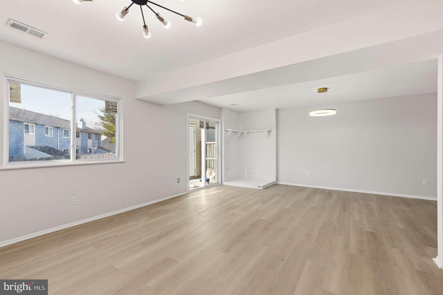 804 Mason Run Pine Hill, NJ 08021 - Photo 10 of 15 a view of an empty room with a window and wooden floor