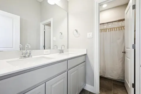 a bathroom with a double vanity sink mirror and