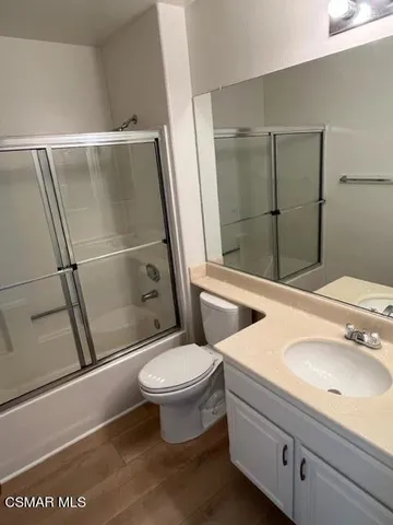 a bathroom with a sink a mirror and a toilet