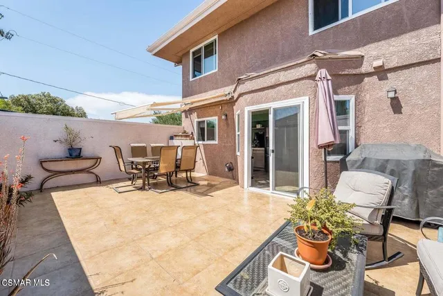 a view of a patio with table and chairs and potted plants
