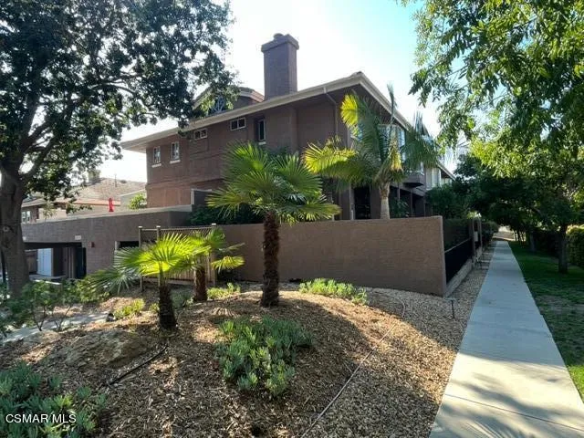 a view of a chair and table in the backyard