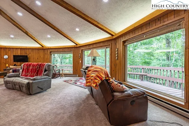 a bedroom with furniture and large windows