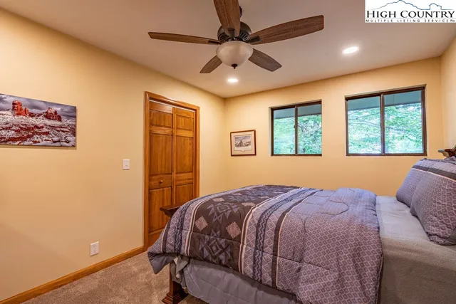 a bedroom with a large bed and a window