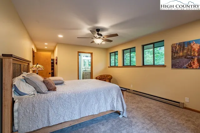 a bedroom with a large bed and a chandelier