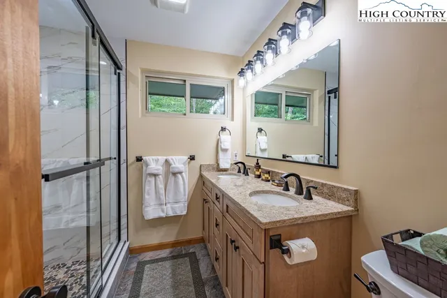 a bathroom with a sink a mirror and a toilet