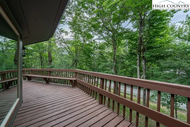 a view of balcony with deck and yard
