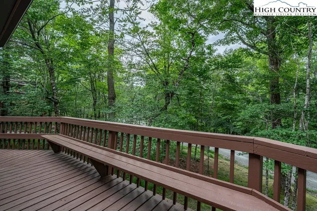 a view of a house with a yard patio and a tree