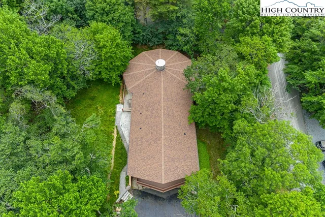 a backyard of a house with a yard and outdoor seating