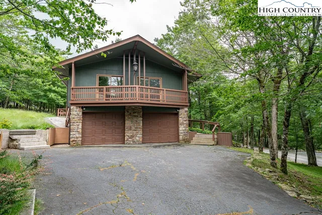 a front view of a house with a garden and garage