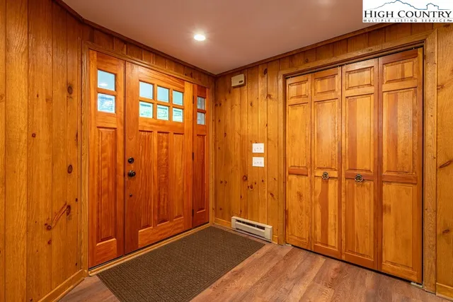 a view of an empty room with wooden floor