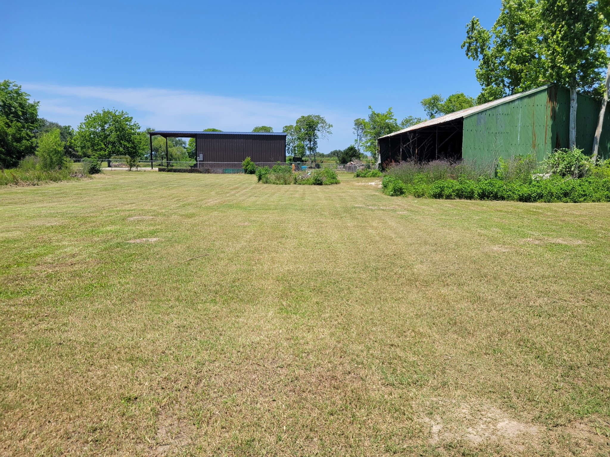 a view of a field with an house in the background