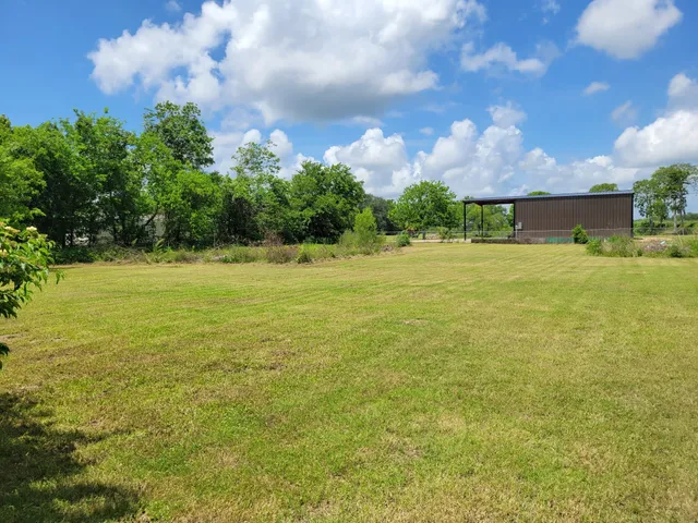 a backyard of a house with lots of green space