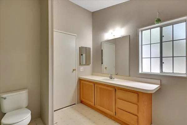 a bathroom with a toilet sink and mirror