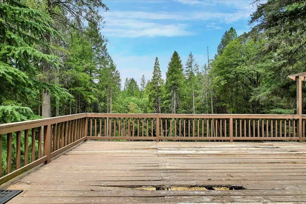 a balcony with wooden floor and fence