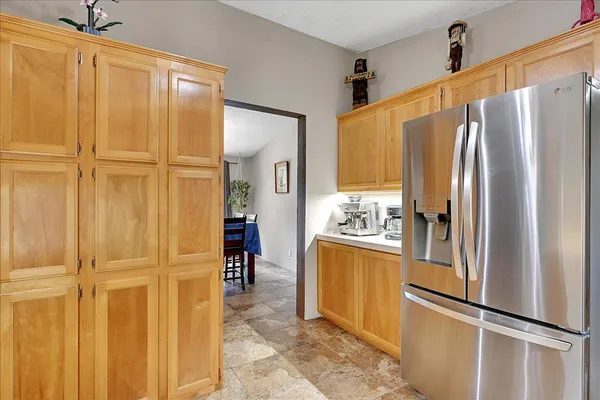 a kitchen with stainless steel appliances granite countertop a refrigerator and cabinets