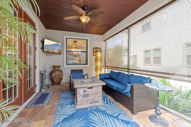 a balcony with furniture and a potted plant