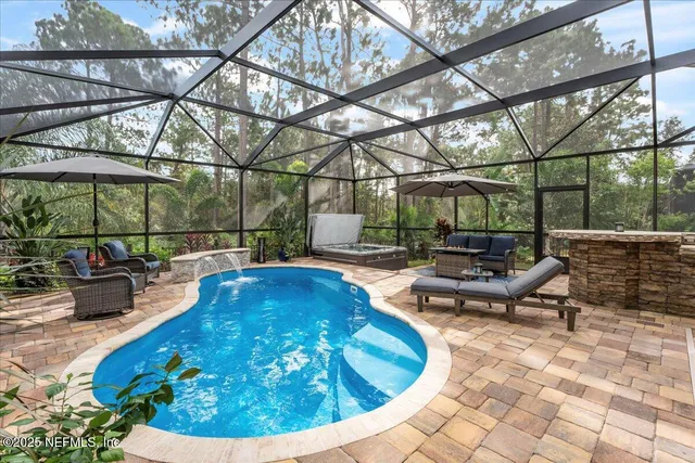 a bedroom with a bed and a large window with view of bedroom