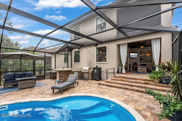 a bathroom with a granite countertop double vanity sink and a mirror