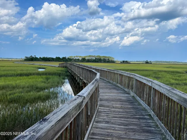 an aerial view of residential houses with outdoor space and river