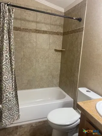 a bathroom with a toilet and a bathtub