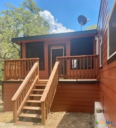 a view of entryway with wooden floor and front door