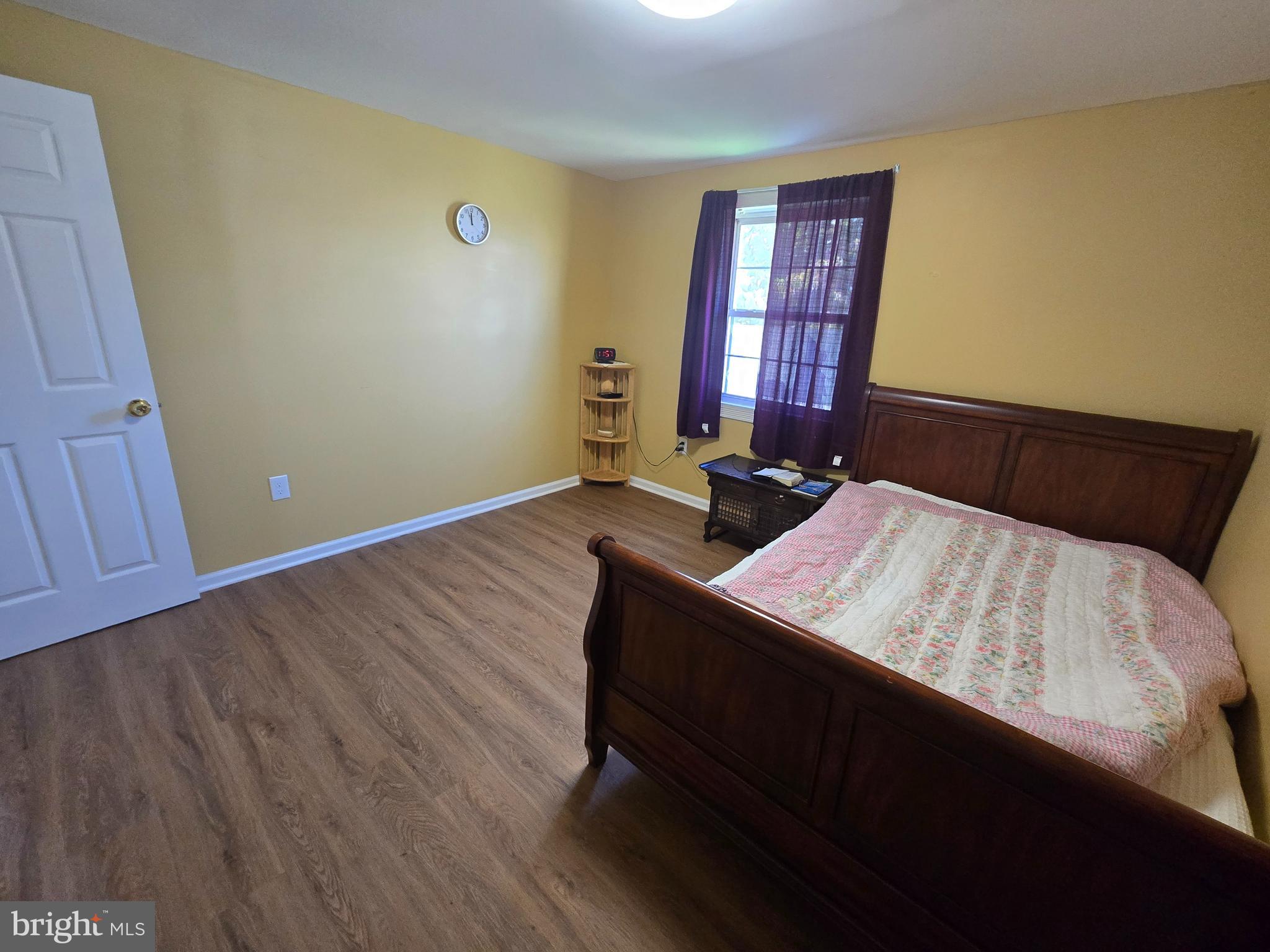 194 Atlantic Avenue Hamilton, NJ 08609 - Photo 12 of 43 a bed sitting in a bedroom next to a window