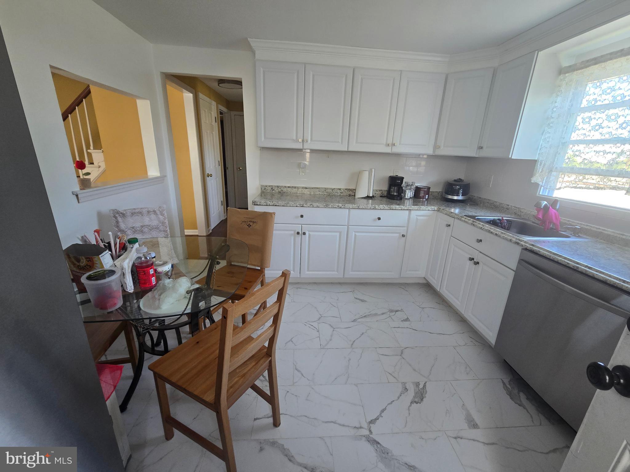 194 Atlantic Avenue Hamilton, NJ 08609 - Photo 21 of 43 a kitchen with a chair and cabinets