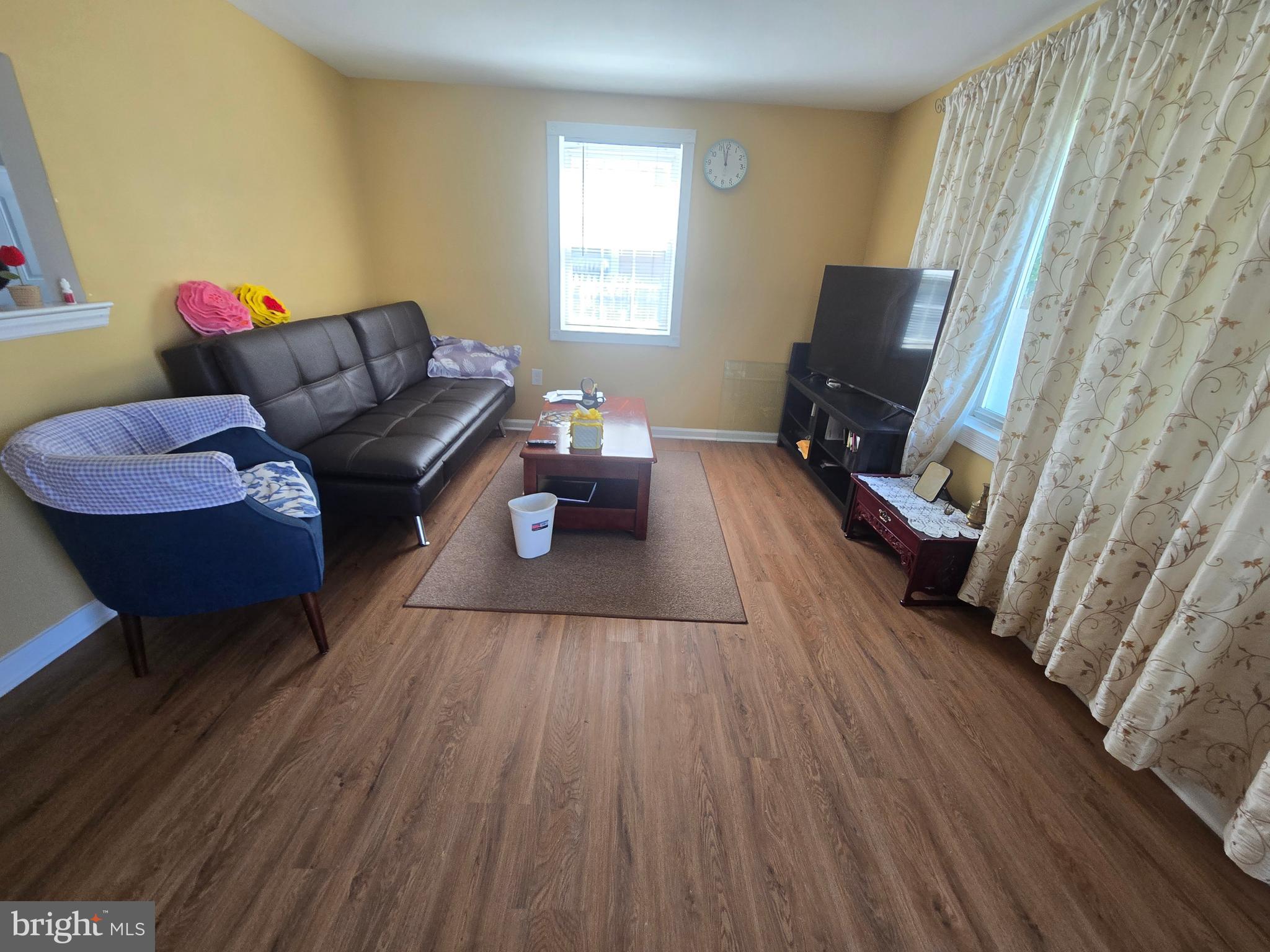 194 Atlantic Avenue Hamilton, NJ 08609 - Photo 9 of 43 a living room with furniture and a flat screen tv