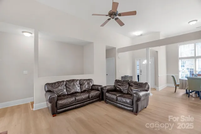 a living room with furniture and a ceiling fan