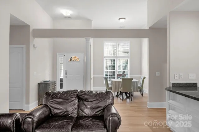 a dining room with furniture and wooden floor