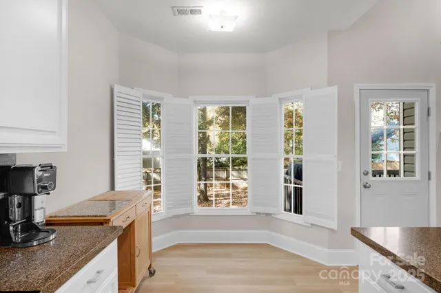 a kitchen with granite countertop a sink and a counter top space