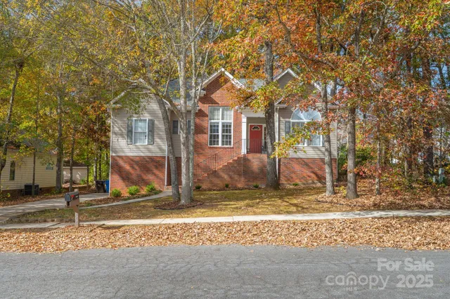 a view of a house with a yard covered in snow