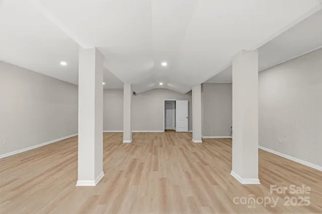 a view of an empty room with wooden floor